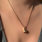 Recycled 14k Gold Molten Drop Charm hanging from gold bead chain.