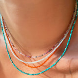 Four shimmering beaded slim gemstone necklaces made of 2mm faceted round stones in moonstone, tourmaline, carnelian and natural turquoise on a gold linking lobster clasp