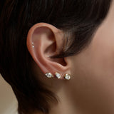 Marquise, pear, and oval molten solitaire diamond studs up the ear.