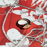 marquise molten solitaire ring on red floral print