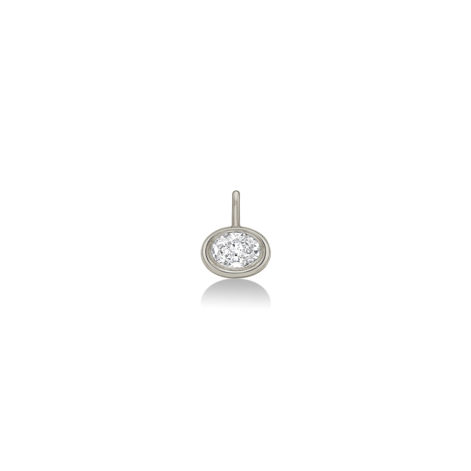 An AMANDA PEARL molten solitaire oval charm in 14K recycled white gold, featuring an ethical lab grown diamond sits on a neutral white background.  