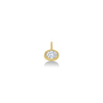 An AMANDA PEARL molten solitaire oval charm in 14K recycled yellow gold, featuring an ethical lab grown diamond sits on a neutral white background.  