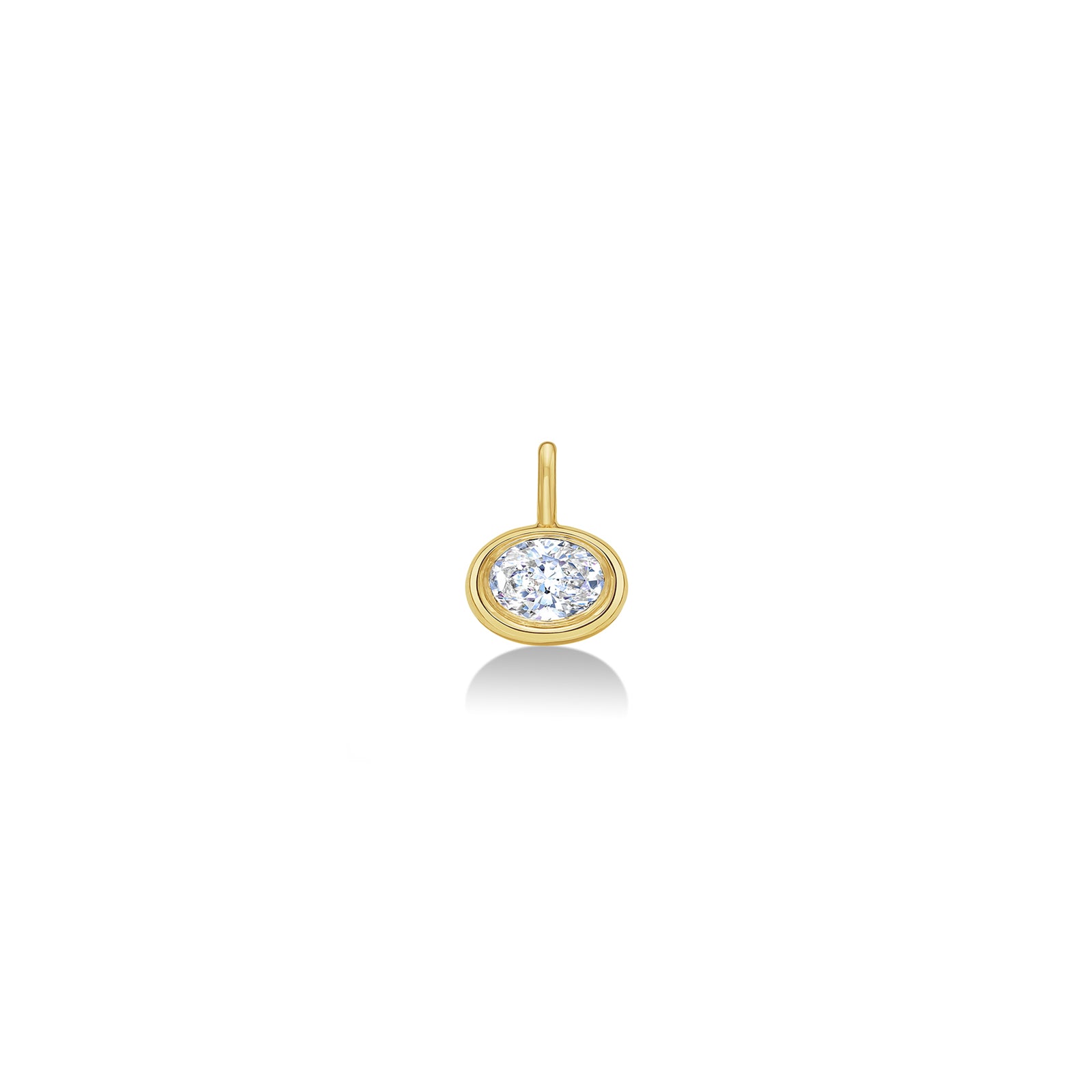 An AMANDA PEARL molten solitaire oval charm in 14K recycled yellow gold, featuring an ethical lab grown diamond sits on a neutral white background.  