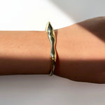 14k recycled Gold Molten Cuff Bracelet, pictured on a wrist