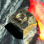 14K recycled gold Molten Midi Ear Cuff layered on a molten lava photo