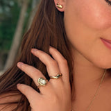 14K recycled gold Molten Ring styled on a hand with the molten knot ring