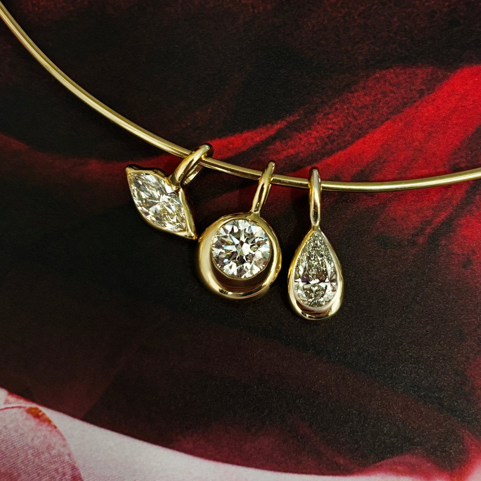 14K Recycled Gold Molten Round Solitaire Charm with Diamond accent layered on a wire choker with the Molten Marquise Solitaire Charm and Molten Pear Solitaire Charm