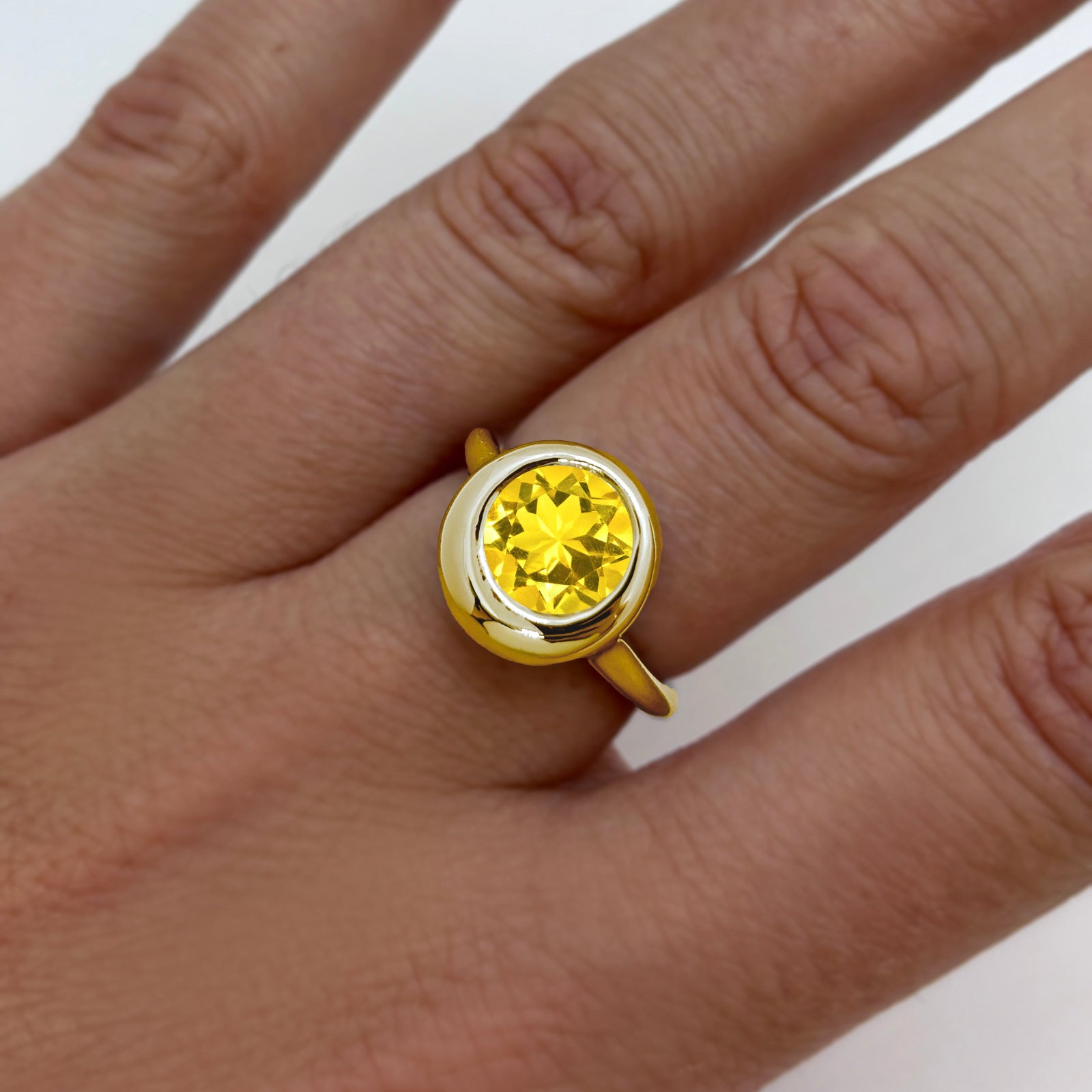 AMANDA PEARL recycled 14k gold Molten Solitaire Ring with citrine gemstone on a model's hand.