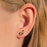 Liquid 14K Recycled gold round small molten stud earring on an ear layered with the Molten Stud