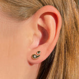 Liquid 14K Recycled gold round small molten stud earring on an ear layered with the Molten Stud