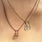 14K Recycled Yellow Gold Number 8 and 9 Charm styled on a chain