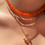 14k recycled gold Plain Ripple Charm. Hanging from a diamond cut cable chain necklace layered with a Tourmaline Slim Gemstone necklace and Orange Faceted Opal Necklace