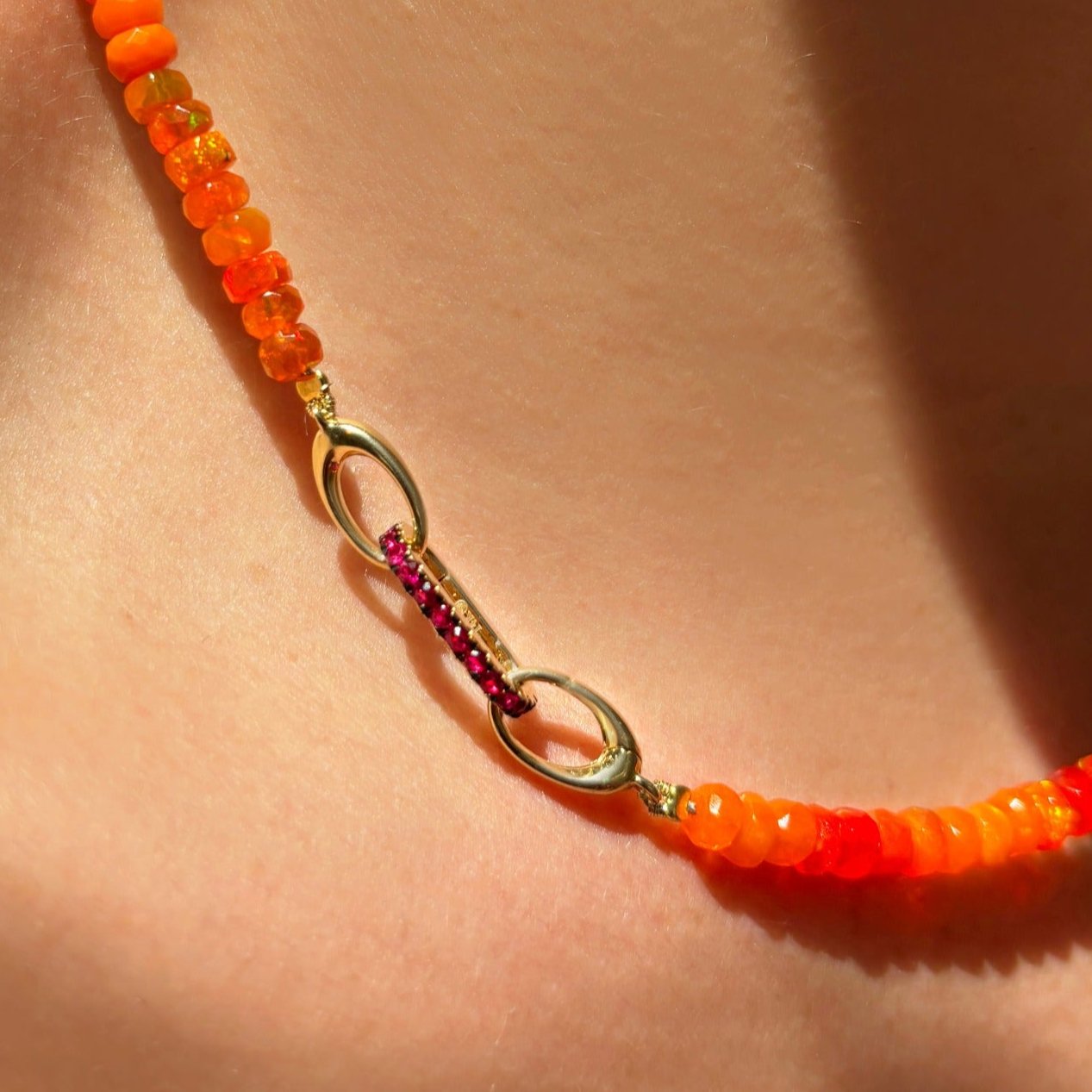 14K Gold Small Ruby Charm Lock styled on an Orange Faceted Opal Necklace on a neck