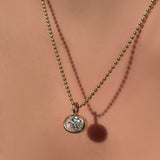 14K Recycled Gold Molten Solitaire Oval Charm styled on a Yellow Gold Bead Chain 