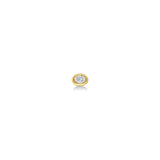An oval molten solitaire stud shot from straight on in 14K yellow gold, with a diamond.