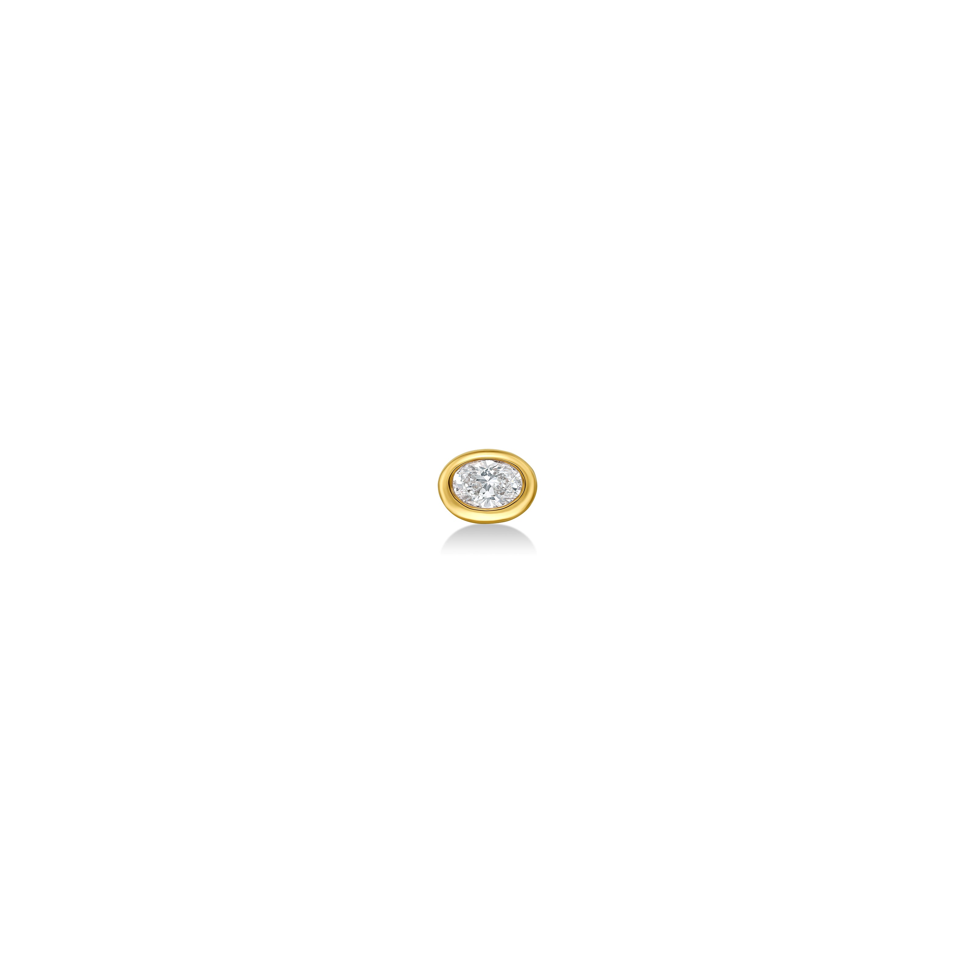 An oval molten solitaire stud shot from straight on in 14K yellow gold, with a diamond.