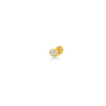 An oval molten solitaire stud shot from three quarters view on in 14K yellow gold, with a diamond.