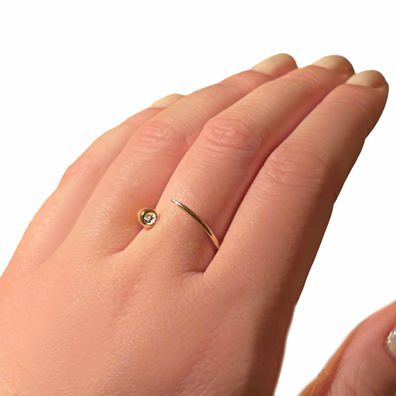 Quill Bypass Ring with 14k recycled yellow gold and a bezel set ethical lab grown diamond. 