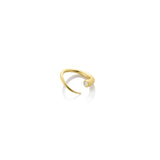 A 14K recycled yellow gold Quill Bypass Ring bezel set with a lab grown round white Diamond on a white background.  