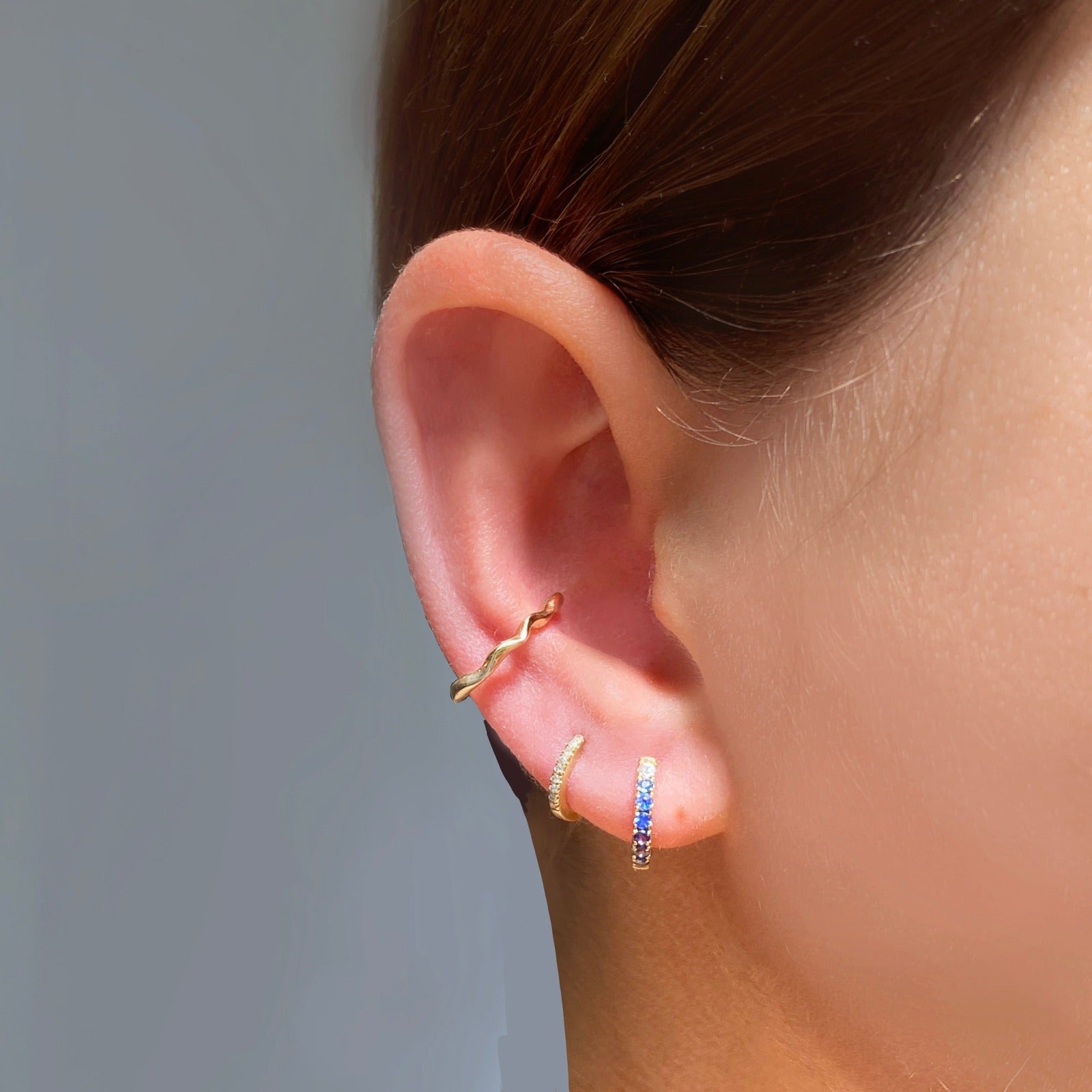 14k gold Ripple Midi Ear Cuff styled on a ear