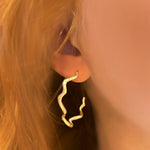 14k gold Demi Pave Ripple Hoop Earring on a ear