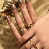 14K Recycled Gold Ripple with marquise stacked with Full Pavé and Plain Ripple Ring on a hand