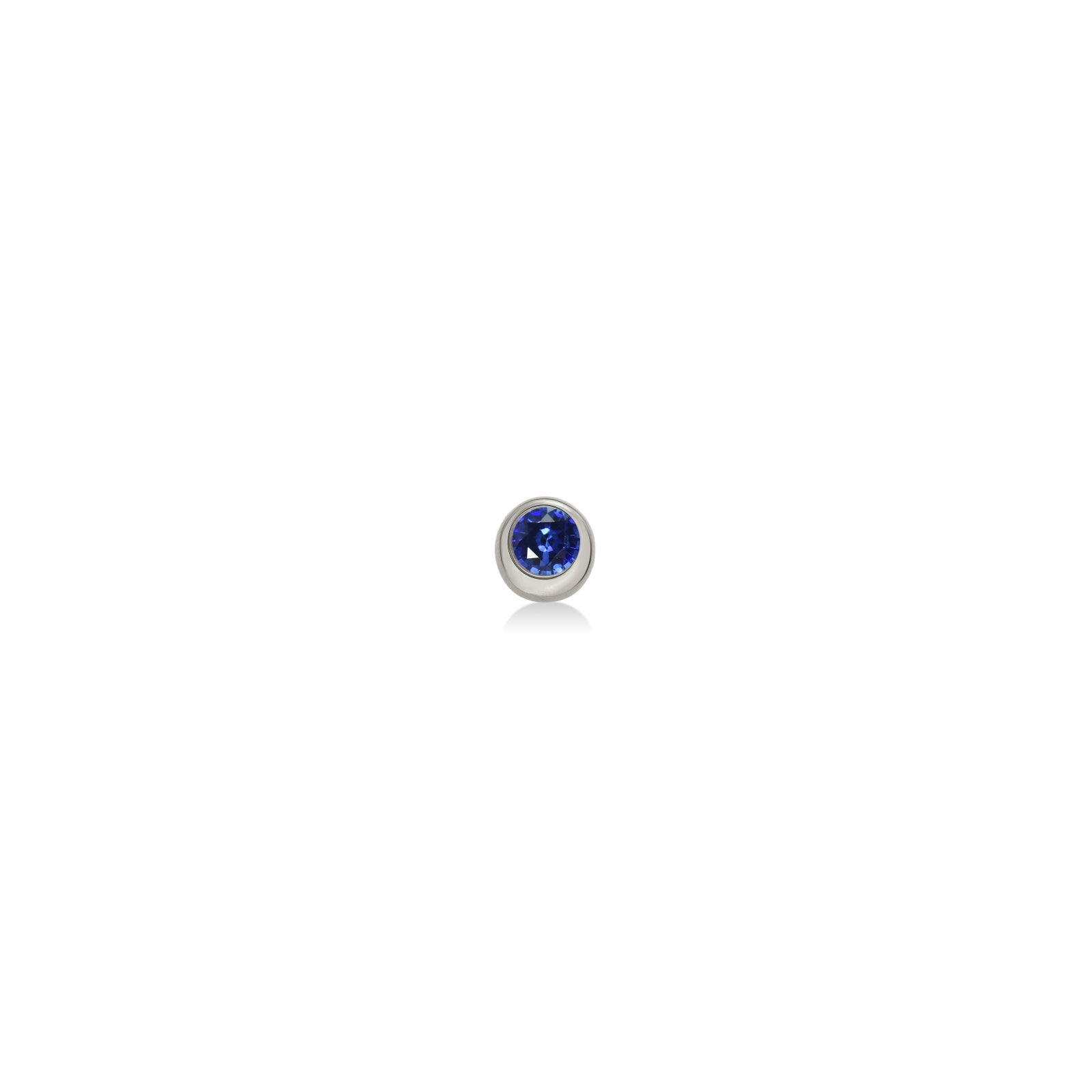 Molten solitaire stud earring in recycled 14k white gold with a round, cultivated sapphire on a white background. 