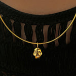 14K recycled Yellow Gold skull charm styled on an omega choker