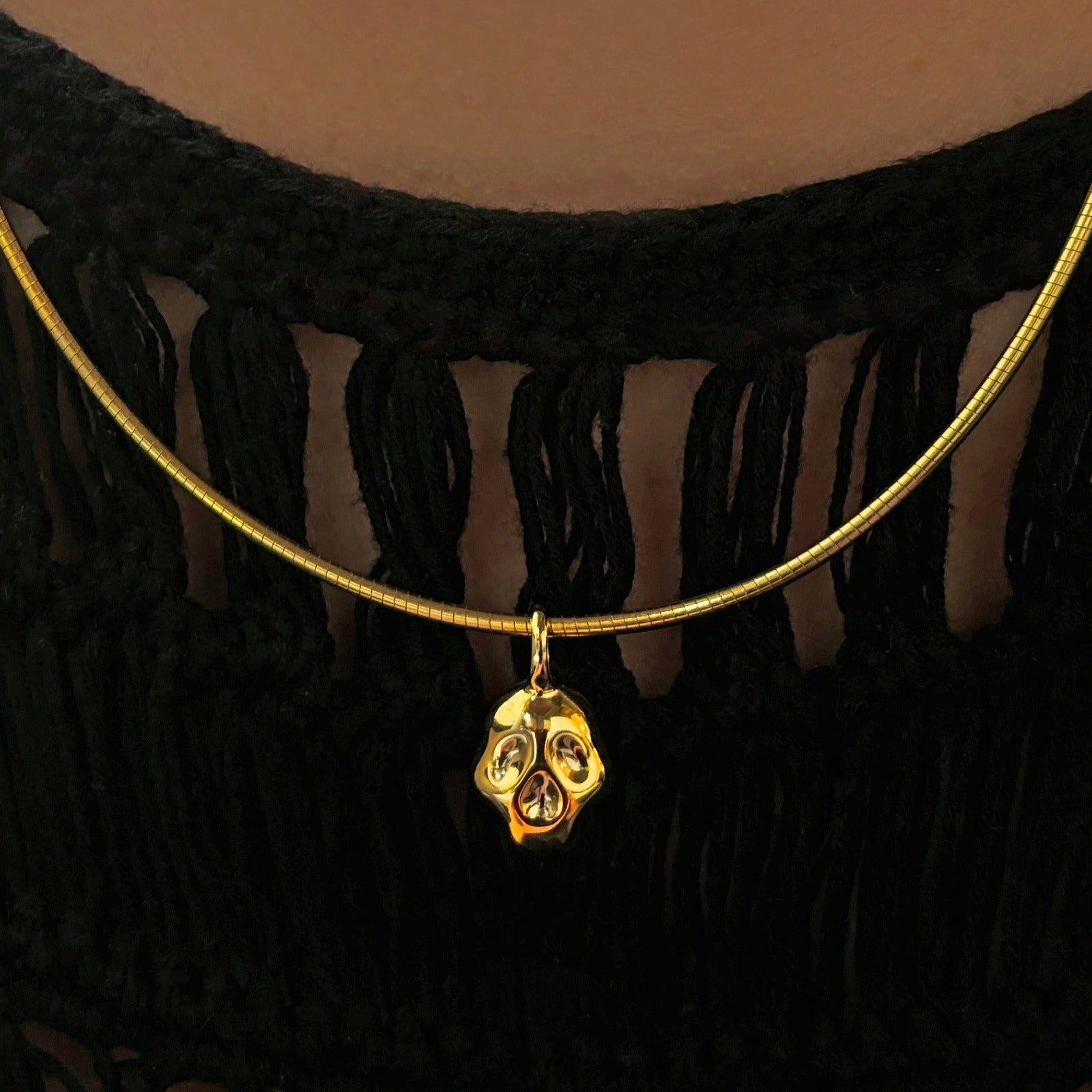 14K recycled Yellow Gold skull charm styled on an omega choker