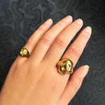 14K recycled Yellow Gold skull pinky ring styled on a hand, with the skull ring