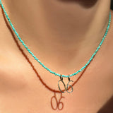 14K Recycled Yellow Gold Number Zero and six Charm styled on a turquoise slim gemstone
