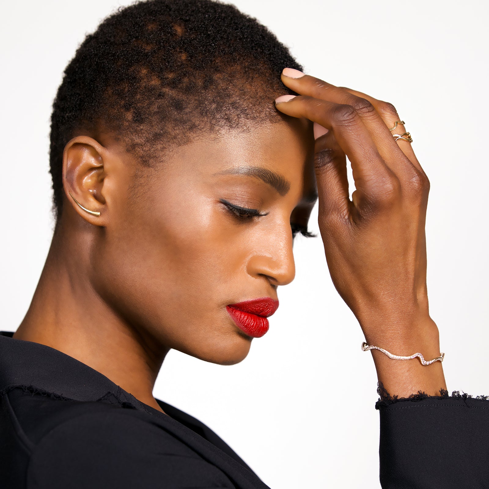 A model shows off her 14k white gold Full Pave Ripple Cuff Bracelet styled on a wrist. 